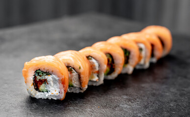 Japanese sushi rolls on a stone background