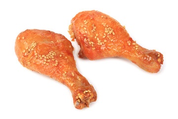 Two roasted drumsticks on a white background.