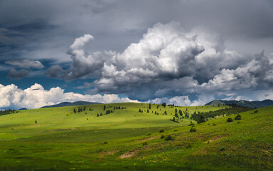 Fototapeta na wymiar Clouds over green hills.