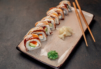 delicious sushi rolls on a stone background