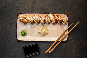 delicious sushi rolls on a stone background