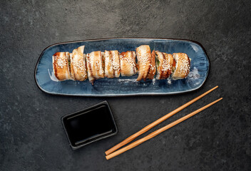 delicious sushi rolls on a stone background