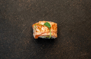 one sushi roll on a stone background