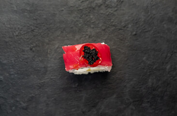 one sushi roll on a stone background