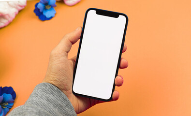 Man using smartphone mockup with blank white screen, flat lay workspace design