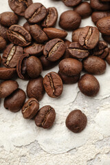 Rich brown coffee beans macro on white clay background