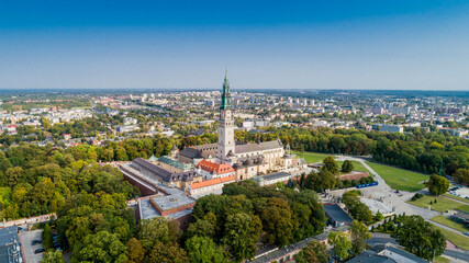 Poland, Częstochowa. Jasna Góra fortified monastery and church on the hill. Famous historic place and 
Polish Catholic pilgrimage site with Black Madonna miraculous icon. Aerial view in fall. - obrazy, fototapety, plakaty