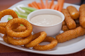 Onion rings and cheese sticks with veggies