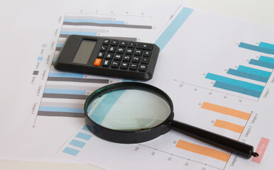 Calculator with magnifying glass on the diagrams