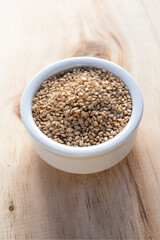 sesame seed in white bowl on wood