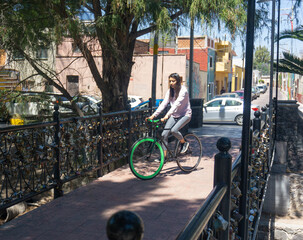 woman riding bicycle in a bridge with padlocks