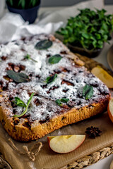 Homemade apple pie sprinkled with icing sugar. Charlotte pie with apples