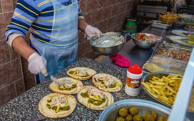 Cook prepares falafels at the bar in Al Jaya town, Jordan