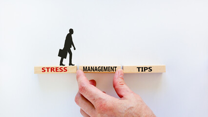 Stress management tips symbol. Wooden blocks with words 'Stress management tips'. Beautiful white background. Doctor hand. Psychological, business and stress management tips concept. Copy space.