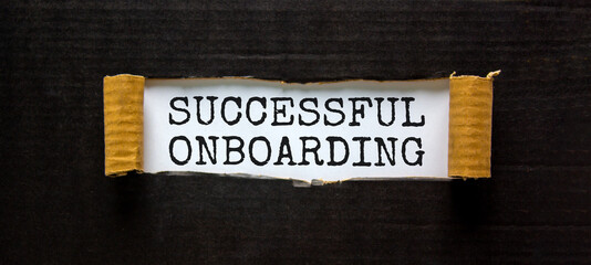 Successful onboarding symbol. Words 'Successful onboarding' appearing behind torn black paper. Beautiful black background. Business, successful onboarding concept, copy space.