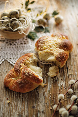 Traditional yeast challah with crumble on a wooden table, close up view.