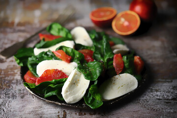 Healthy salad with spinach, mozzarella and red orange. Diet food. Fitness food.