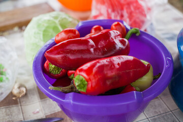 Organic food, red paper on table at daylight.