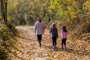 Obraz premium Family hiking , mother and her daughters relax on beautiful autumn sunny day in nature