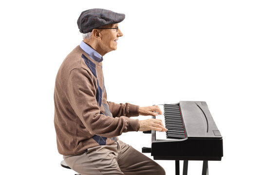 Profile shot of an elderly man playing a digital piano