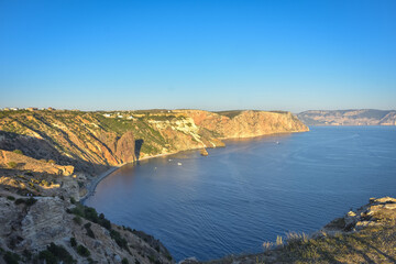 Fototapeta premium Cape Fiolent. Beautiful views of the Black Sea coast at Cape Fiolent in summer in clear weather. Aerial view to beautiful sea coast with turquoise water and rocks
