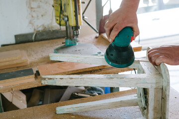 Restoration of furniture. Grinding machine.