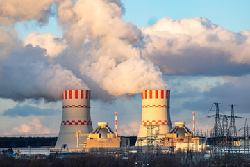 Cooling tower with steam of Atomic nuclear power station. Industrial zone of nuclear with emission...