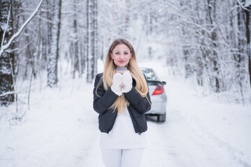 Portrait of a beautiful girl in winter clothes in the winter