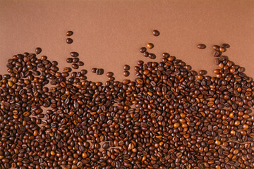 Roasted brown coffee beans. Top view. Brown coffe background.