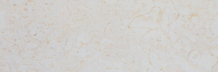 Dolomite texture. Natural rock with beautiful beige patterns on the surface. Polished flat stone. Classic luxury decoration building material. Wide panoramic texture for background and design.