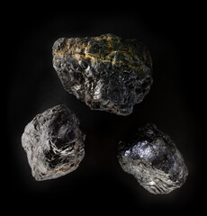 An anthracite hard-coal carbon mineral nugget from Donbass, Ukraine. A photo of stone isolated on black. For Geology minerology websites, stone collection catalog, Natural Science museum wall charts
