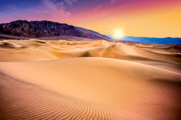 Fototapeta na wymiar Death Valley, California sand dunes with colorful sunset