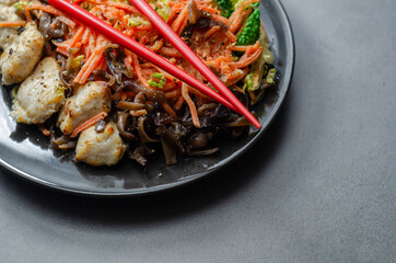 Cooked chicken breast pieces with egg noodles, carrots, and cabbage in a savory chow mein sauce