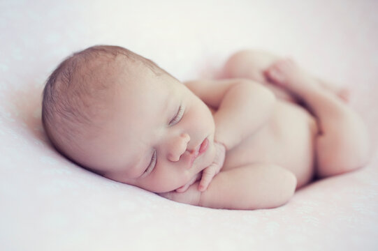 Newborn baby sleeps on blanket. Time to sleep for infant. Hairy baby girl or boy portrait