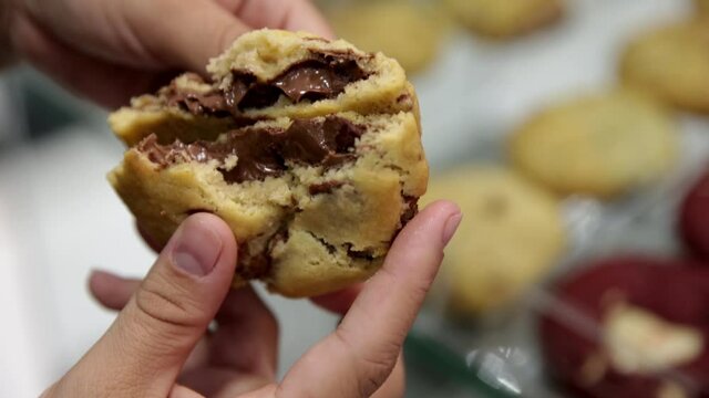 Gooey melted chocolate inside a freshly baked cookie at a modern bakery - isolated close up