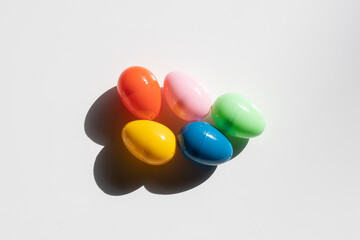 Five colorful plastic Easter eggs in the sun isolated on a white background.