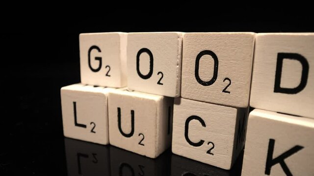 Letters on cubes write the words Good Luck - probe lens close up shot