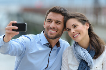 couple wearing casual clothing taking selfie