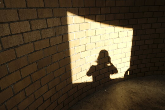 Shadow Of Woman On Tiled Floor