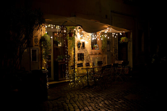 Cafe lights on a rainy night in Trastevere, Rome Italy