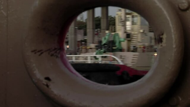 The Port of Buenos Aires seen from the Drain Hole of a Moving Tugboat. 
