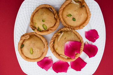 Popular Indian mithai or sweets known as chandrakal. round dumpling deep fired sweet eaten during festivals and special occassions like holi festival or eid festival