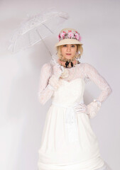 Girl wearing 19th Century fashion style, lady high society renaissance corset and long skirt holding sun shade happy and smiling  