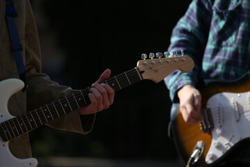 electric guitar neck in the hands of a street musician