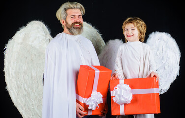 Valentines angels with gift box. Happy father with little son in angel costume with present.