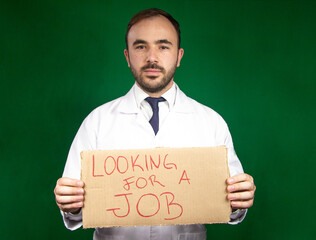 Young doctor with unrecognizable face holding a sign that says 