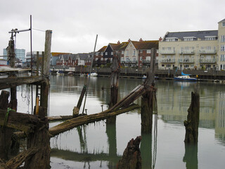View of the old boat mooring beams, canal and buildings