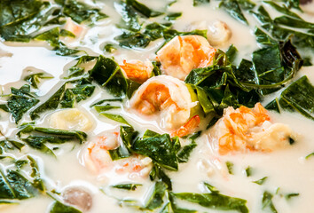 Cooking Melindjo leaves in coconut milk soup with prawn, Thai southern famous food