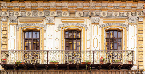 Colonial style balcony with flowers panorama, Cuenca city, Ecuador.