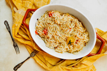 trendy vegan healthy food. pasta from feta cheese with small tomatoes in olive oil with herbs and...